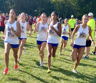 Girls Varsity Cross Country racing at a meet, courtesy of @lakeforestxc instagram